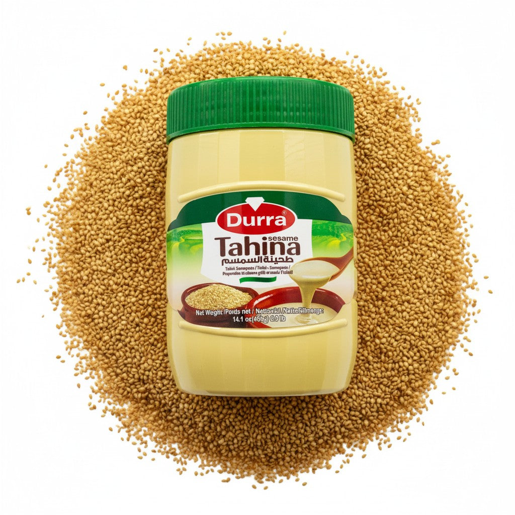 babaGOURMET Durra Original Tahini sesame paste in a light yellow plastic jar with a green lid. Features an illustration of sesame seeds and tahini on a spoon.