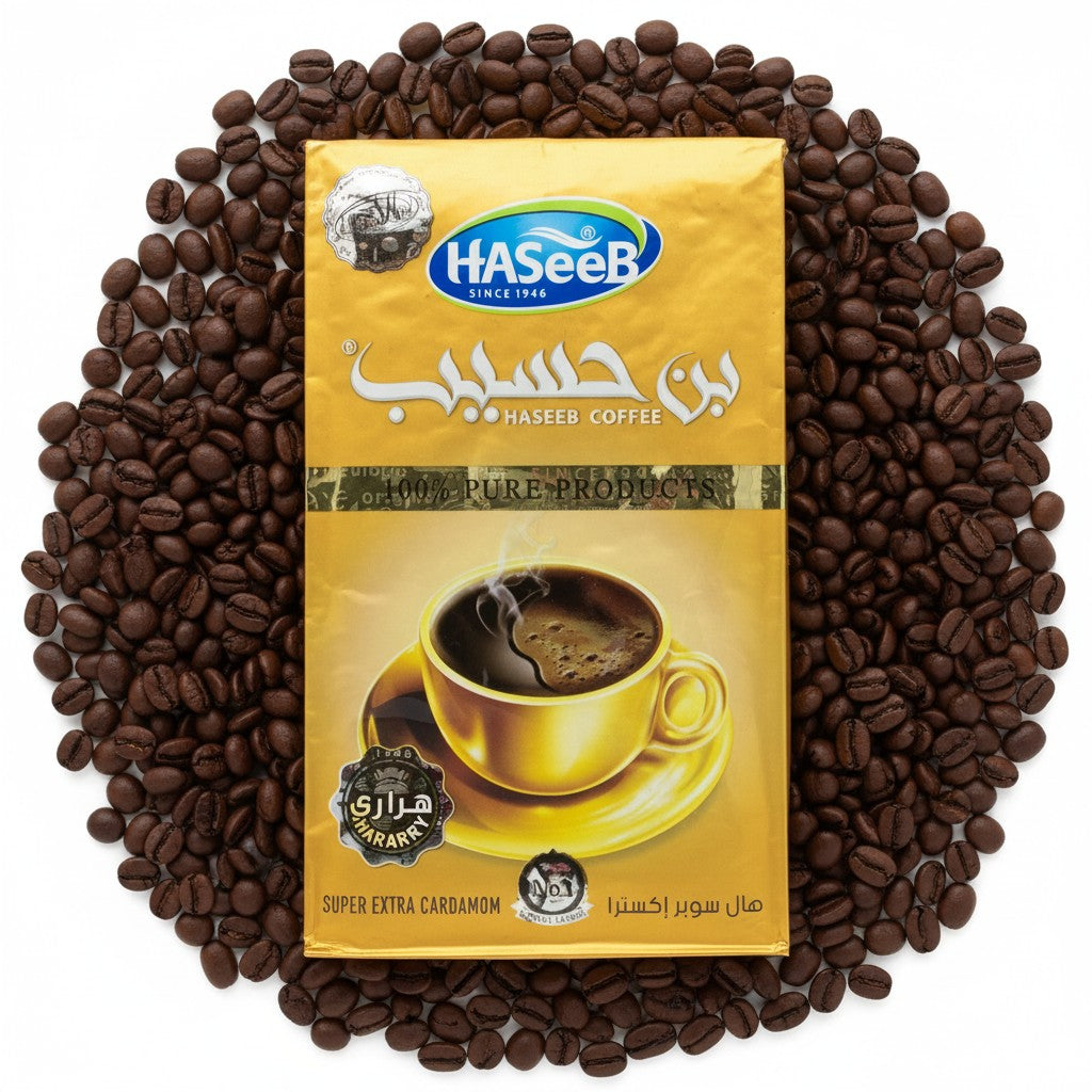 babaGOURMET Haseeb ground Arabic coffee with super extra cardamom, 500g bag. Features a steaming cup of dark coffee on a saucer.